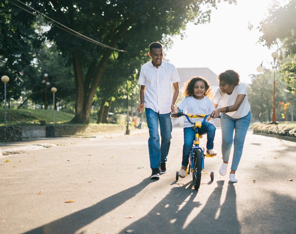Family with child on a bike taking a stroll