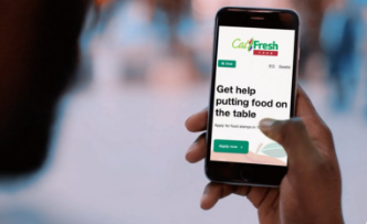 Person looking at their phone with Get CalFresh on the screen