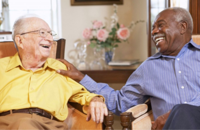 Two men talking to each other in a living room.