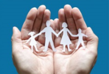 hands_cropped hands holding a paper cutout of a family