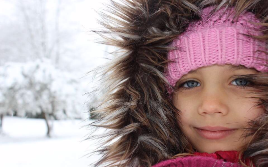 Close up of little girl with a snow background